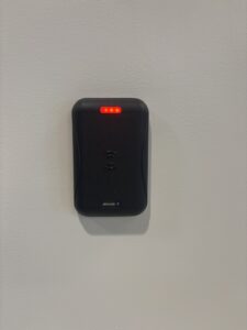 Technician installing a keypad access device at an apartment entry