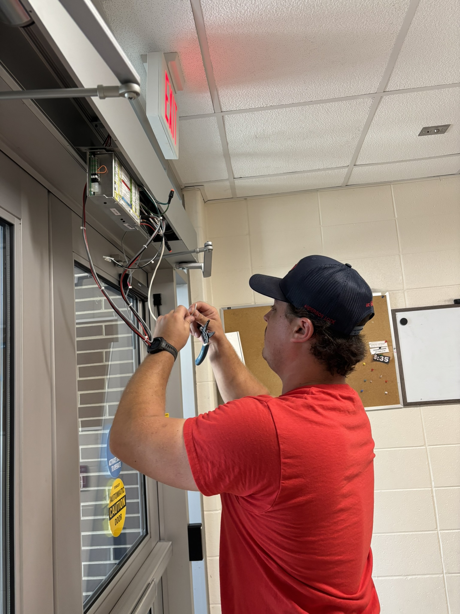Technician installing an ADA-compliant automatic door operator