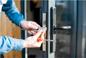 Technician working near a door lock in a commercial setting
